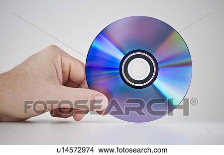 Picture - Hand holding compact disc. Fotosearch