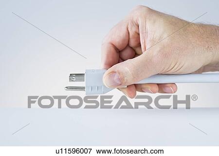 Hand holding plug View Large Photo Image Stock Photo - Hand holding plug. Fotosearch