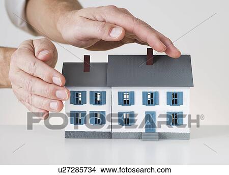 Hands touching toy house View Large Photo Image Picture - Hands touching toy house. Fotosearch