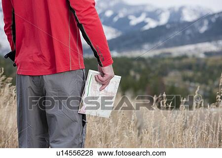 Stock Photo - Hiker holding a map. Fotosearch