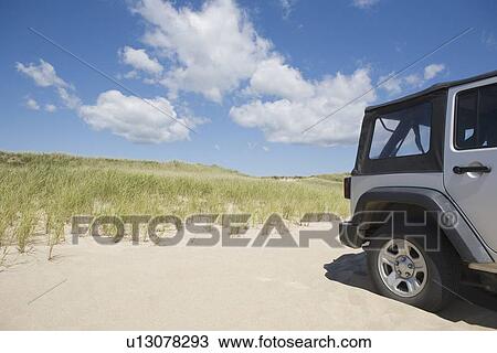 Stock Image - Jeep on the beach. Fotosearch