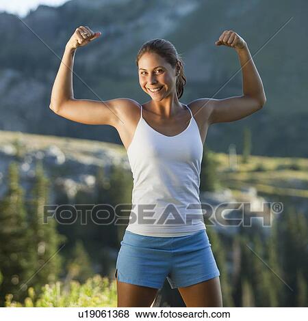 Stock Photo - Jogger flexing her muscles. Fotosearch