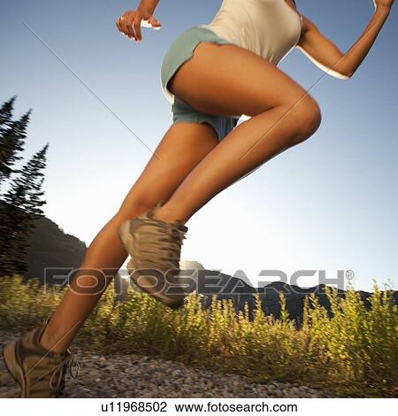 Stock Image - Jogger on rural trail. Fotosearch