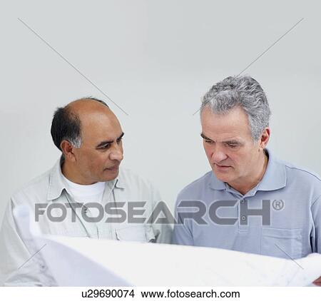 Picture - Looking at blueprints. Fotosearch