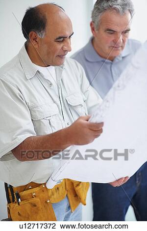 Looking at blueprints View Large Photo Image Stock Image - Looking at blueprints. Fotosearch