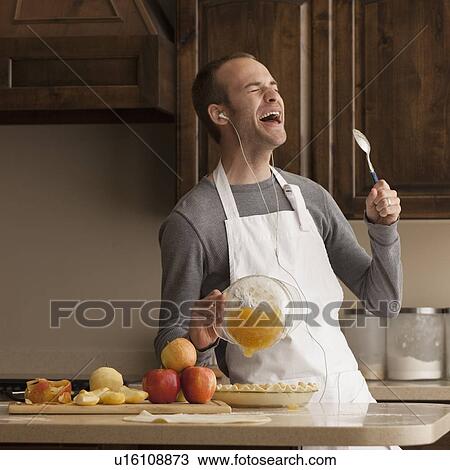 Man baking and listening to music View Large Photo Image Stock Image - Man baking and listening to music. Fotosearch