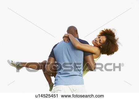 Man carrying woman View Large Photo Image Stock Image - Man carrying woman. Fotosearch