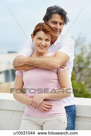 Picture - Man embracing woman. Fotosearch