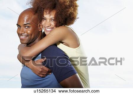 Man giving woman a piggy back ride View Large Photo Image Picture - Man giving woman a piggy back ride. Fotosearch