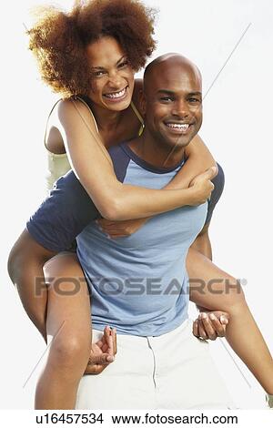 Man giving woman a piggy back ride View Large Photo Image Picture - Man giving woman a piggy back ride. Fotosearch