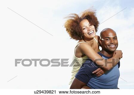 Man giving woman a piggy back ride View Large Photo Image Stock Image - Man giving woman a piggy back ride. Fotosearch