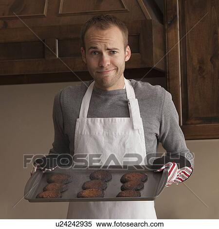 Man holding tray of burnt cookies View Large Photo Image Stock Photography - Man holding tray of burnt cookies. Fotosearch