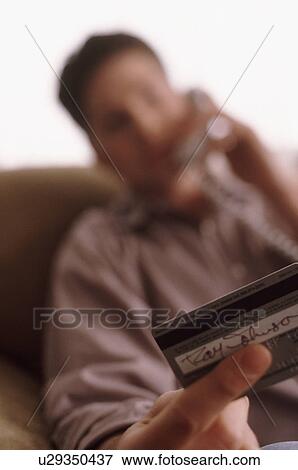 Stock Photo - Man making credit card purchase. Fotosearch