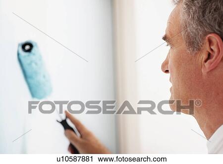 Stock Image - Man painting wall. Fotosearch