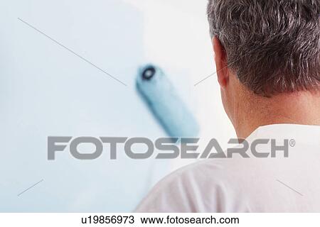Stock Image - Man painting wall. Fotosearch