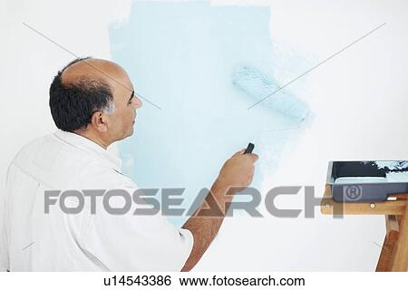 Stock Photograph - Man painting wall. Fotosearch