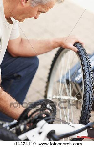 Man repairing bicycle View Large Photo Image Stock Image - Man repairing bicycle. Fotosearch