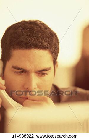Stock Image - Man talking on the telephone. Fotosearch