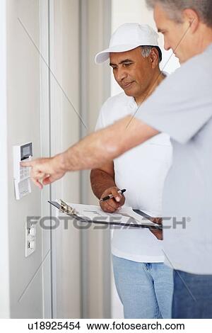 Man testing alarm system View Large Photo Image Picture - Man testing alarm system. Fotosearch