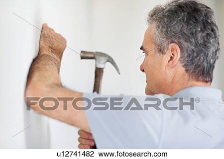 Man using a hammer View Large Photo Image Stock Image - Man using a hammer. Fotosearch