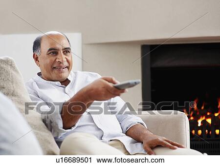 Stock Image - Man watching television. Fotosearch