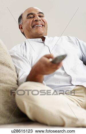 Man watching television View Large Photo Image Stock Image - Man watching television. Fotosearch