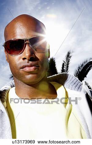 Stock Photo - Man wearing sunglasses. Fotosearch
