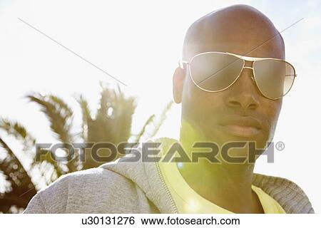 Stock Photograph - Man wearing sunglasses. Fotosearch