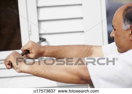Stock Photo - Man working with crowbar. Fotosearch