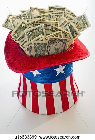 Money in Uncle Sam's hat View Large Photo Image Stock Photo - Money in Uncle Sam's hat. Fotosearch