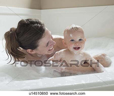 Mother and baby having bubble bath View Large Photo Image Stock Image - Mother and baby having bubble bath. Fotosearch