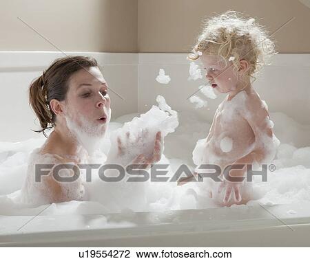 Stock Image - Mother and child having bubble bath. Fotosearch