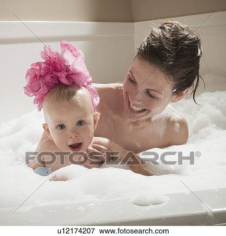 Stock Photo - Mother and child having bubble bath. Fotosearch