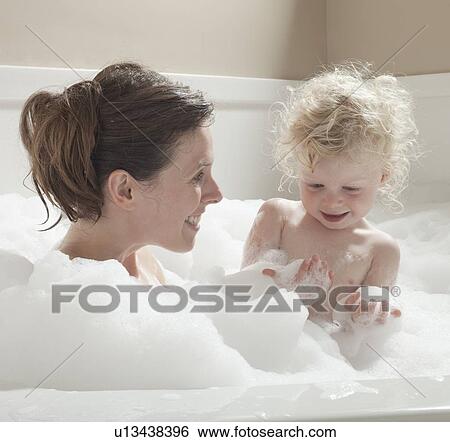 Stock Photograph - Mother and child having bubble bath. Fotosearch