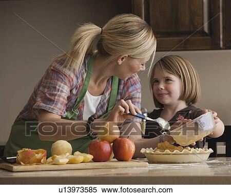Mother and daughter baking apple pie View Large Photo Image Stock Photography - Mother and daughter baking apple pie. Fotosearch
