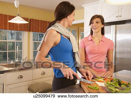 Mother and daughter in kitchen View Large Photo Image Stock Photo - Mother and daughter in kitchen. Fotosearch