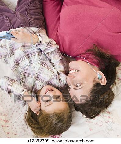 Mother and daughter listening to music View Large Photo Image Stock Photo - Mother and daughter listening to music. Fotosearch