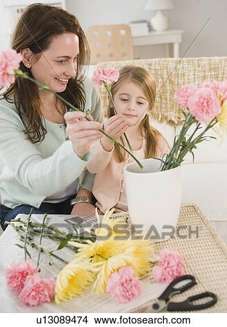 Picture - Mother and daughter making flower arrangement. Fotosearch