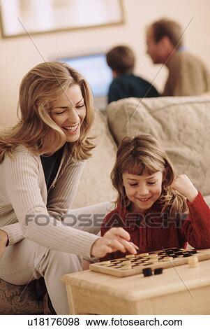 Mother and daughter playing checkers View Large Photo Image Stock Photo - Mother and daughter playing checkers. Fotosearch