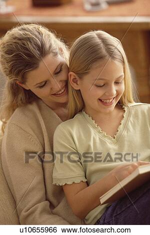 Mother and daughter reading together View Large Photo Image Stock Photograph - Mother and daughter reading together. Fotosearch