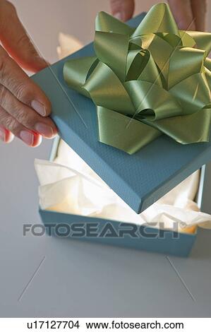 Picture - Opening a gift. Fotosearch