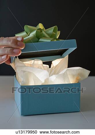 Opening a gift View Large Photo Image Stock Image - Opening a gift. Fotosearch