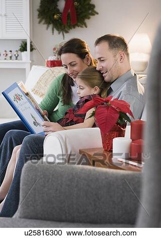 Parents reading to daughter View Large Photo Image Stock Image - Parents reading to daughter. Fotosearch