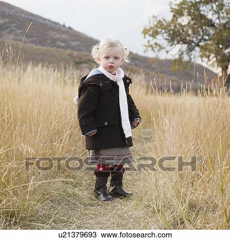 Stock Image - Portrait of a girl in a meadow. Fotosearch