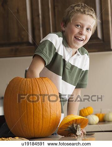 Stock Image - Pumpkin carving. Fotosearch
