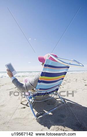 Reading at the beach View Large Photo Image Stock Image - Reading at the beach. Fotosearch