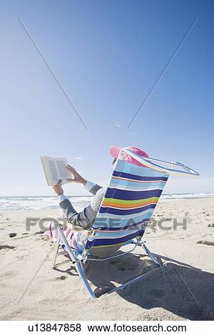 Reading at the beach View Large Photo Image Stock Photo - Reading at the beach. Fotosearch