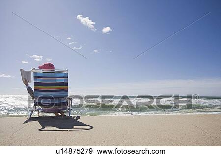 Reading at the beach View Large Photo Image Stock Photo - Reading at the beach. Fotosearch