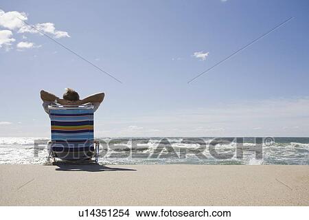 Picture - Relaxing on the beach. Fotosearch