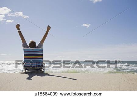 Stock Photo - Relaxing on the beach. Fotosearch